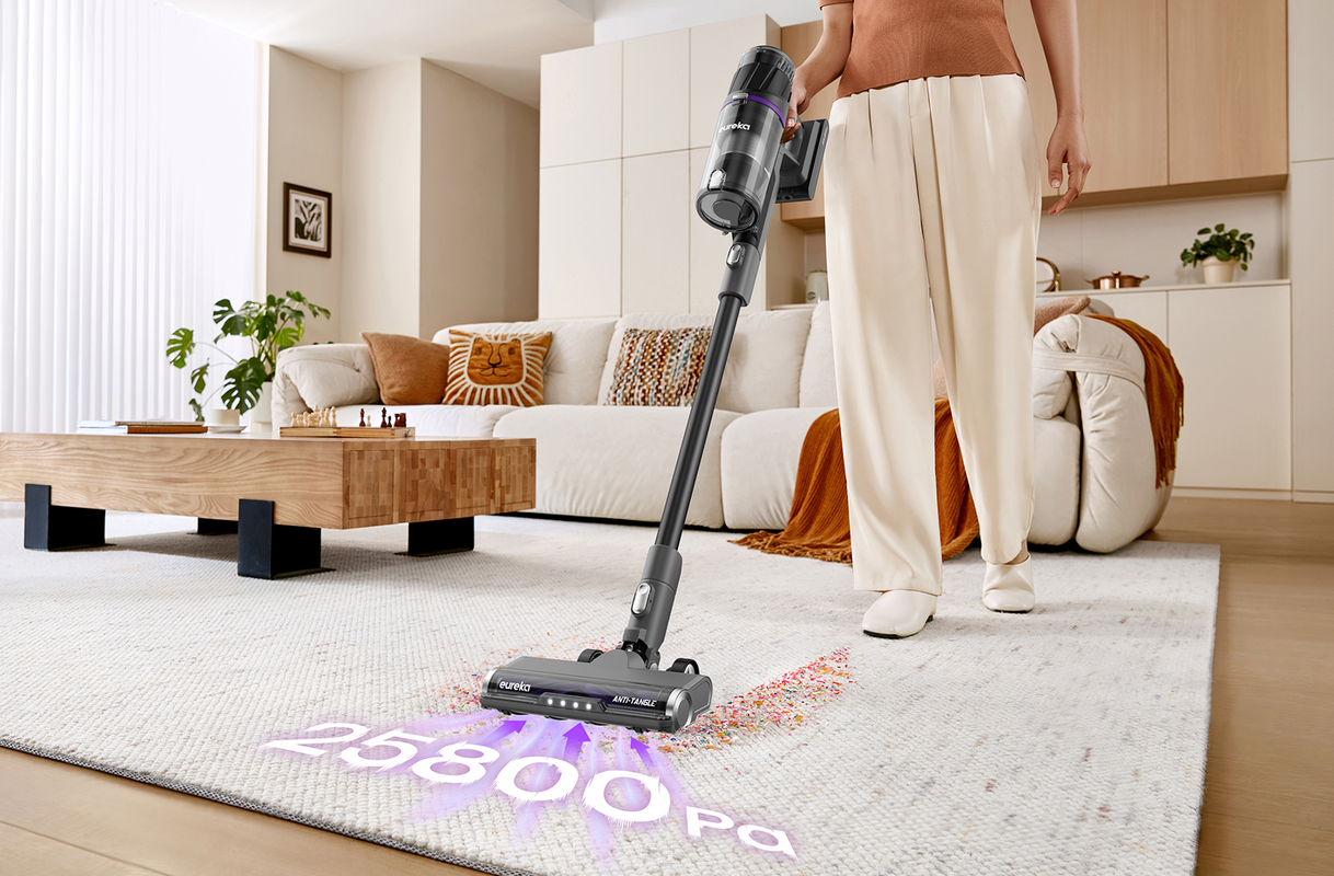 Black and silver cordless vacuum cleaner with multiple attachments on a white background