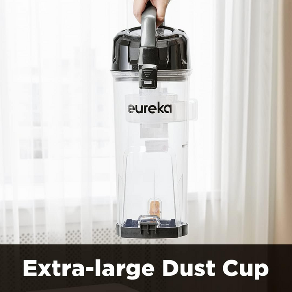 Eureka extra-large dust cup held by a hand with a white curtain background